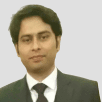 A man in a black coat with a white shirt and tie